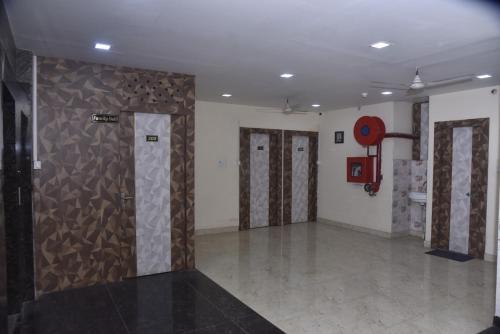 a room with a wall with doors and a basketball hoop at Hotel R S RESIDENCY in Varanasi
