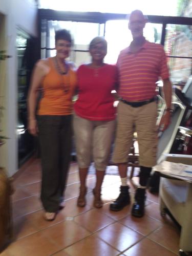 a group of three people standing in a room at Casa Blanca Tu Casa in Santa Ana