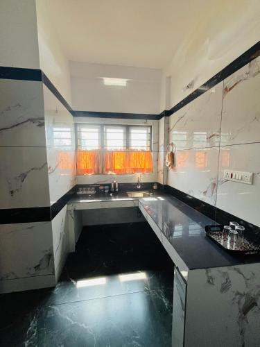 a kitchen with a sink and a counter top at Tea vista holiday home in Kalpetta
