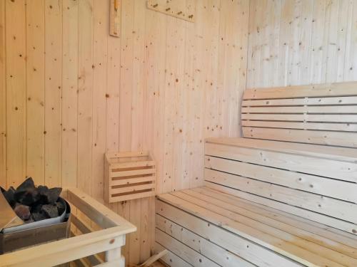 a sauna with wood paneled walls and a tub at Arte Plus Kuala Lumpur in Kuala Lumpur