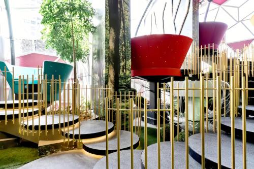 a room with chairs and tables and a window at Arte Plus Kuala Lumpur in Kuala Lumpur