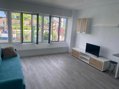 a living room with a couch and a tv at Lucy lux apartament in Las Palmas de Gran Canaria