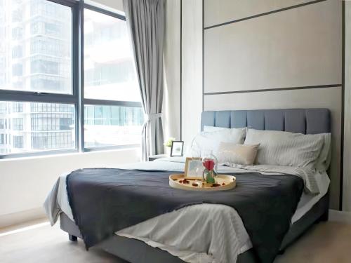 a bedroom with a large bed with a tray on it at Arte Plus Kuala Lumpur in Kuala Lumpur