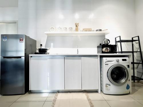 a kitchen with a refrigerator and a washing machine at Arte Plus Kuala Lumpur in Kuala Lumpur