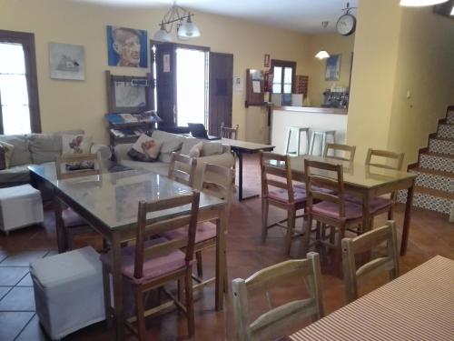 a living room with tables and chairs and a couch at La Posada del Recovero in Genalguacil