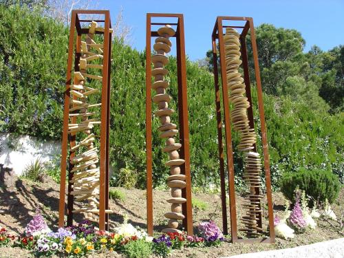 a garden with a bunch of wooden wind sculptures at La Posada del Recovero in Genalguacil