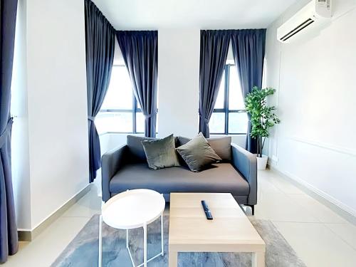 a living room with a couch and a table at Arte Plus Kuala Lumpur in Kuala Lumpur