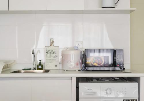 a kitchen counter with a microwave and a toaster at Arte Plus Kuala Lumpur in Kuala Lumpur