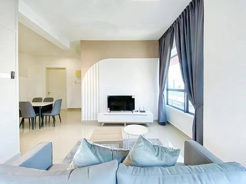 a living room with a couch and a tv at Arte Plus Kuala Lumpur in Kuala Lumpur