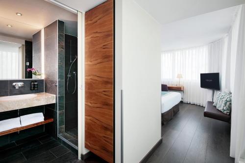 a bathroom with a shower and a sink at Eurostars Embassy in Vienna