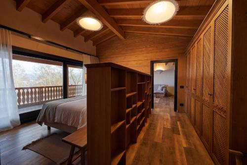 a bedroom with a bed and a balcony at Matca Hotel Relais & Châteaux in Şimon