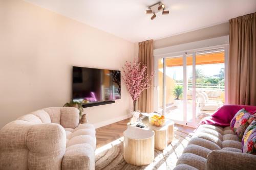 a living room with a couch and a tv at Voramar III by the beach large terrace in Calpe