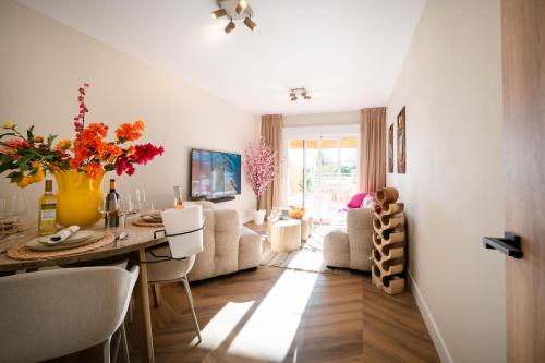 a kitchen and living room with a table and chairs at Voramar III by the beach large terrace in Calpe