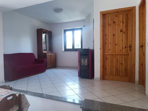 a living room with a red couch and a tv at Home Friends in Camigliatello Silano