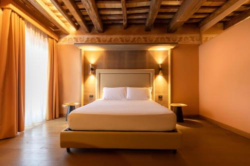 a bedroom with a bed and a large window at Palazzo De Gregorio - Apartments in Palermo