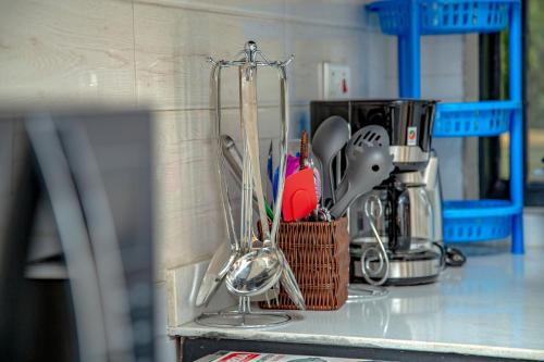 a kitchen counter with utensils in a holder at Rebero A3s apartment in Kigali