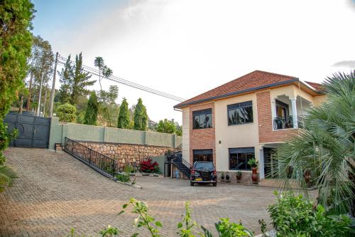 a brick house with a gate and a driveway at Rebero A3s apartment in Kigali