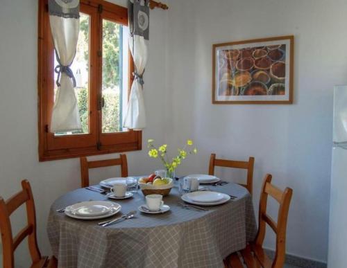 a table with a blue table cloth and a bowl of fruit on it at Angelinas Villas 2 Hab con Piscina in Cala Blanca