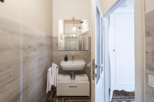 a small bathroom with a sink and a mirror at San Martino Suite in Pisa