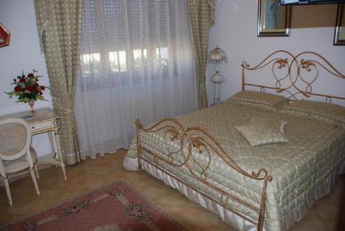 Ένα ή περισσότερα κρεβάτια σε δωμάτιο στο B&B La Rosa Antica