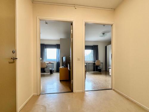 an empty room with an open door to a living room at Logi Tuppen, Vandrarhem - Oskarshamns folkhögskola in Oskarshamn