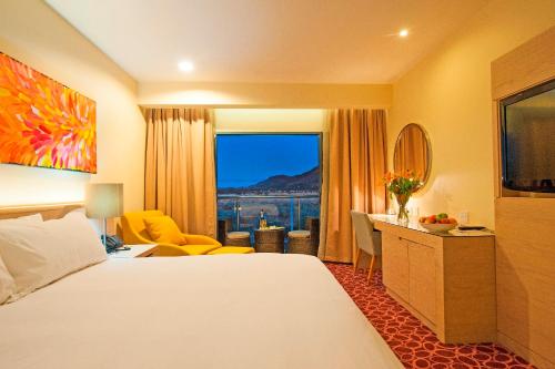 a hotel room with a bed and a large window at Crowne Plaza Alice Springs Lasseters by IHG in Alice Springs