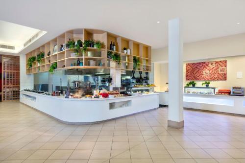 a large kitchen with a counter in a building at Crowne Plaza Alice Springs Lasseters by IHG in Alice Springs