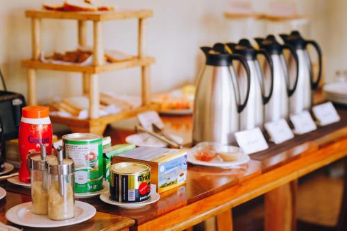 a counter with a table with a bunch of food at Keys Hotel in Moshi