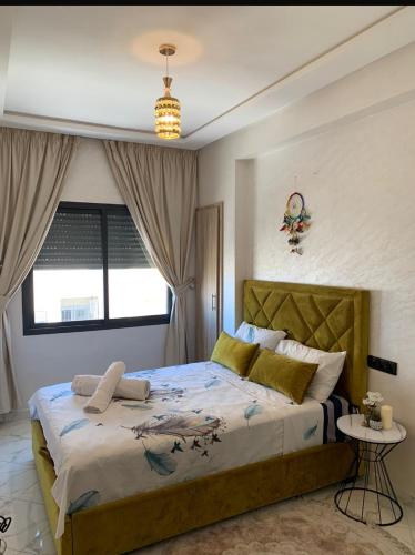 a bedroom with a large bed and a window at Hay al qods in Casablanca