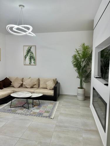 a living room with a couch and a table at Lungomare Luxury Sea View Apartaments in Vlorë