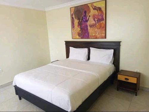 Ένα ή περισσότερα κρεβάτια σε δωμάτιο στο Kigali City Stay