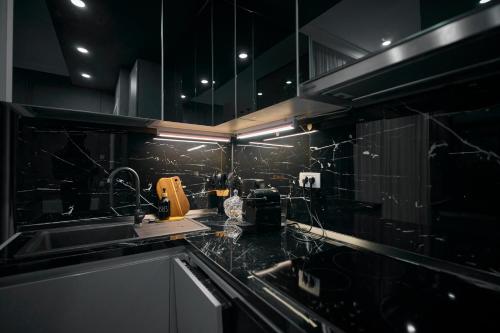 a kitchen with a sink and a counter top at Cozy Glow Loft in Bucharest