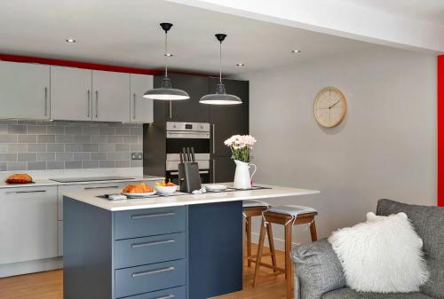 a kitchen with a blue and white counter top at Finest Retreats -Little Granary in Salcombe