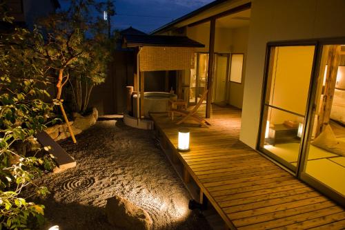 a porch of a house with a wooden deck at Migiwaya in Yaizu
