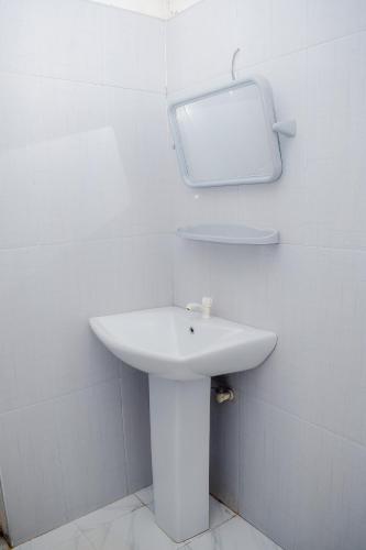 a bathroom with a sink and a mirror on the wall at Hotel Sanjana & Restaurant in Polonnaruwa
