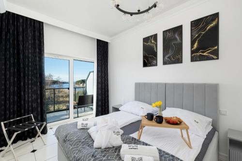 a bedroom with two beds and a table at Luxury Apartment 23 basen i sauna D&D Apartments in Dziwnów