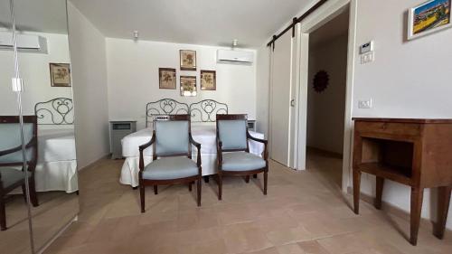 a dining room with a table and chairs and a piano at Agriturismo Pieve San Biagio - Adults Only in Macerata