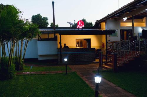 a house with a neon sign on top of it at Keys Hotel in Moshi