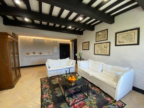 a living room with two white couches and a table at Agriturismo Pieve San Biagio - Adults Only in Macerata
