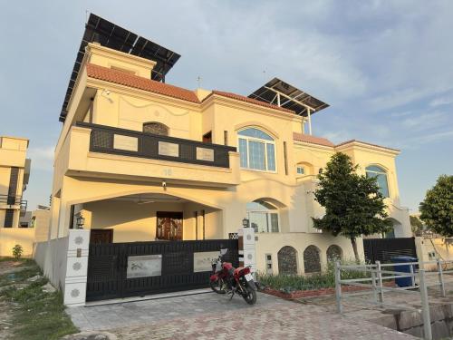 a house with a motorcycle parked in front of it at 2 BHK GF - Villa in Bahria Enclave, Islamabad in Islamabad