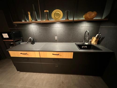 a kitchen with a sink and a counter top at ZONK HOTEL Nakasu-Deaibashi in Fukuoka