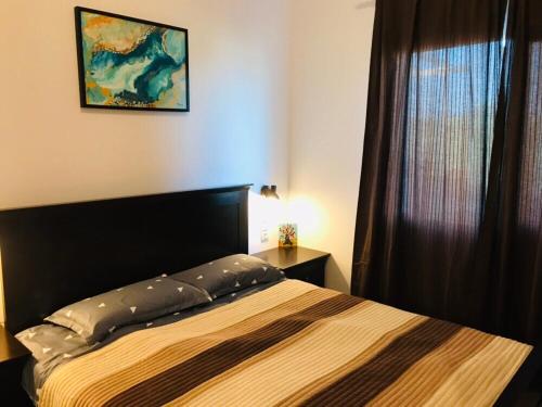 a bedroom with a bed and a window at Samothraki Vacation Home, amazing Saos view, 2BR in Samothráki