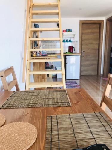 a kitchen with a wooden staircase in a room at Samothraki Vacation Home, amazing Saos view, 2BR in Samothráki