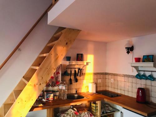 a kitchen with a wooden staircase in a kitchen at Samothraki Vacation Home, amazing Saos view, 2BR in Samothráki