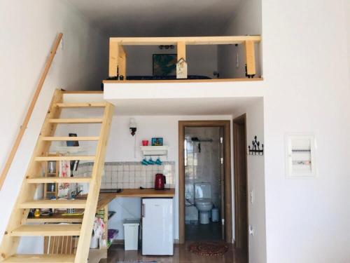 a small room with a loft bed and a kitchen at Samothraki Vacation Home, amazing Saos view, 2BR in Samothráki