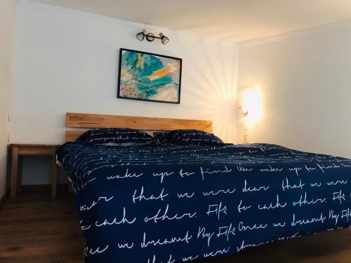 a bedroom with a bed with writing on the bedspread at Samothraki Vacation Home, amazing Saos view, 2BR in Samothráki