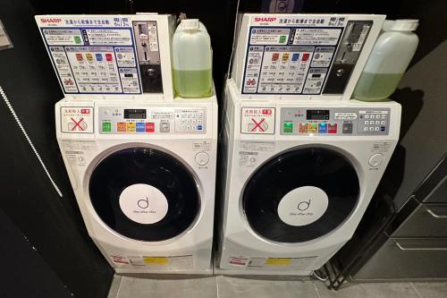 two washing machines stacked on top of each other at ZONK HOTEL Nakasu-Deaibashi in Fukuoka