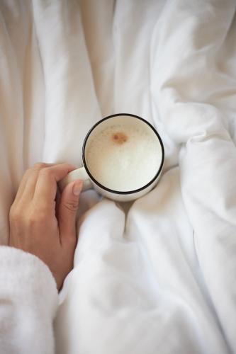 a person is holding a cup of coffee at Heart Hotel in Limassol
