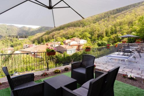 a patio with chairs and a table and an umbrella at Casa nel mare in Biassa