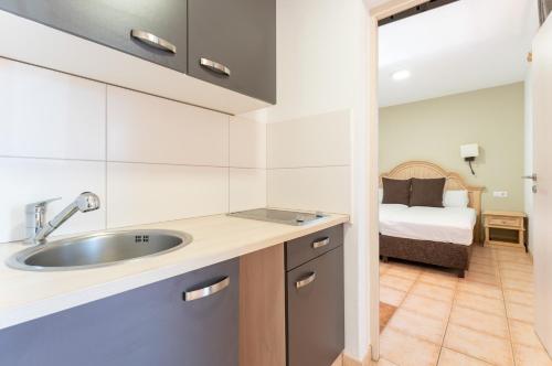 a kitchen with a sink and a bed in a room at Bakour Fuerteventura La Pared in La Pared